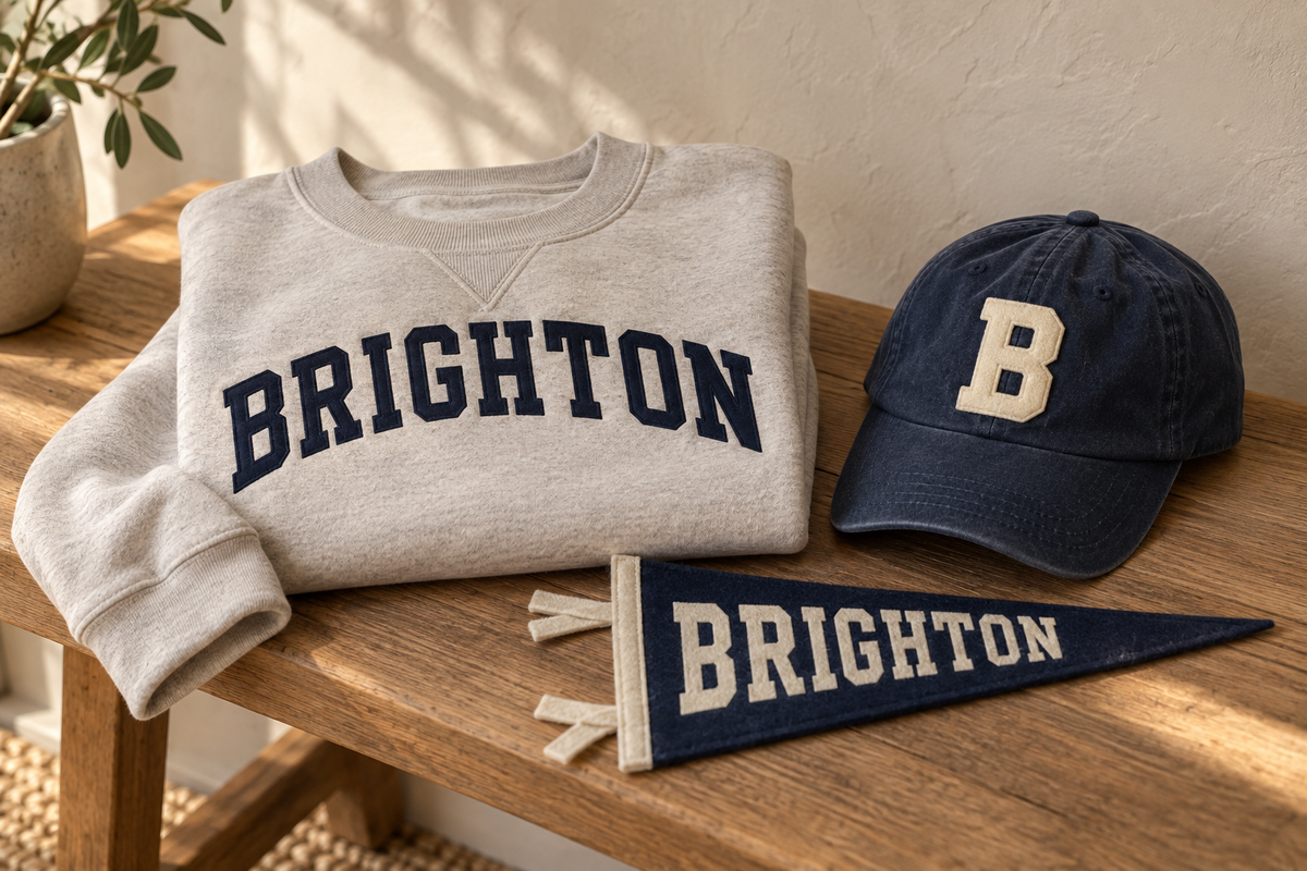 Brighton sweatshirt, navy felt B cap, and Brighton pennant — concept mockups